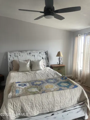 a bed sitting in a bedroom next to a window