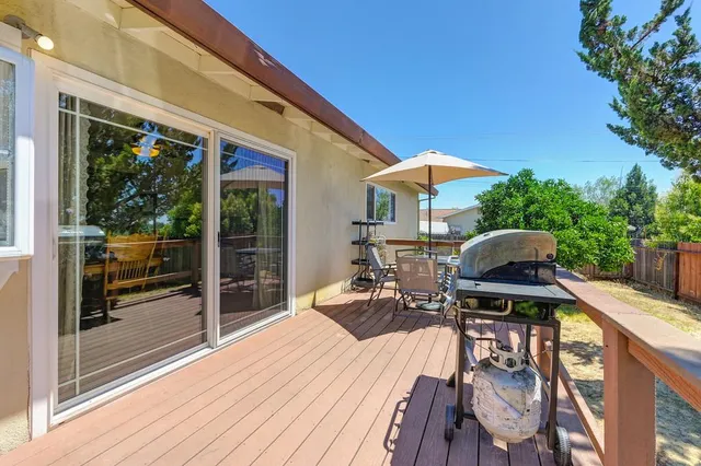 a view of balcony with chairs and wooden fence
