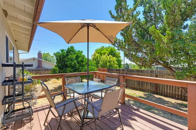 a backyard of a house with table and chairs