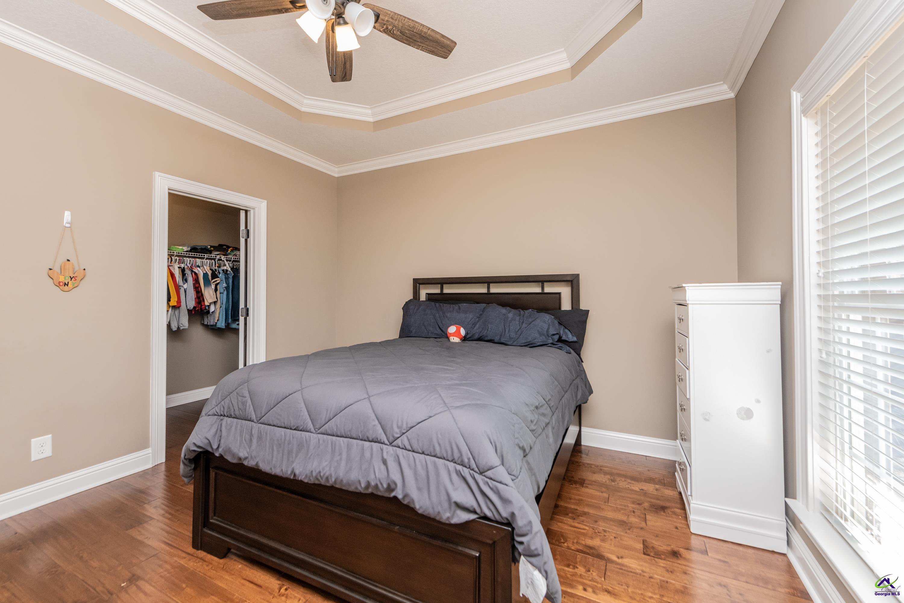 405 Old Bridge Road Warner Robins, GA 31088 - Photo 30 of 58 a bedroom with a bed and a chandelier