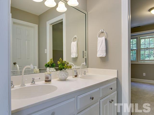 401 Mumm Lane Raleigh, NC 27615 - Photo 16 of 25 a bathroom with a sink and a mirror