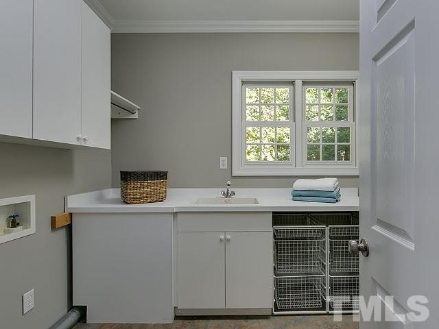 401 Mumm Lane Raleigh, NC 27615 - Photo 22 of 25 a kitchen with a sink cabinets and window