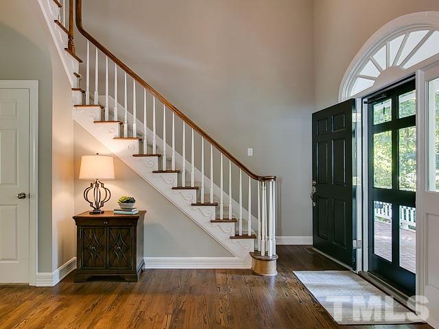 401 Mumm Lane Raleigh, NC 27615 - Photo 4 of 25 a view of an entryway with wooden floor and door