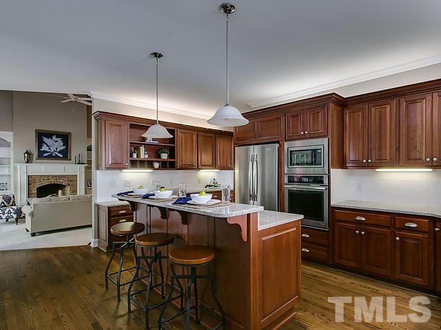 401 Mumm Lane Raleigh, NC 27615 - Photo 7 of 25 a kitchen with cabinets a counter space stainless steel appliances and cabinets