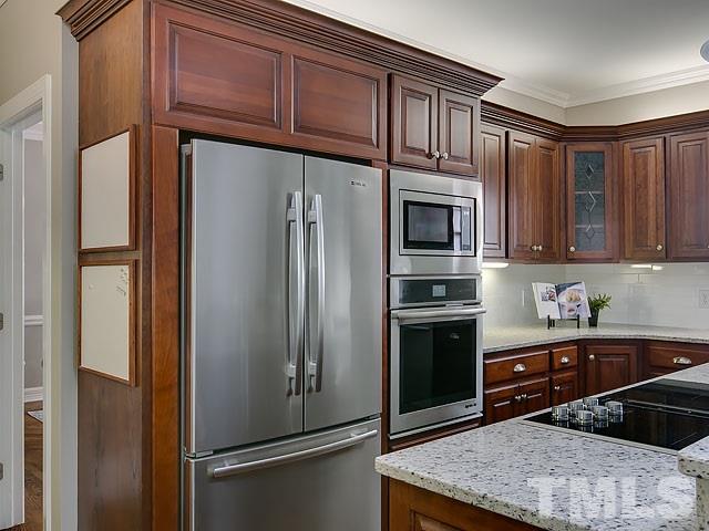 401 Mumm Lane Raleigh, NC 27615 - Photo 8 of 25 a kitchen with stainless steel appliances granite countertop a refrigerator stove and microwave
