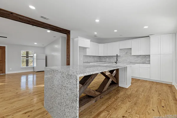 a kitchen with a sink appliances and cabinets