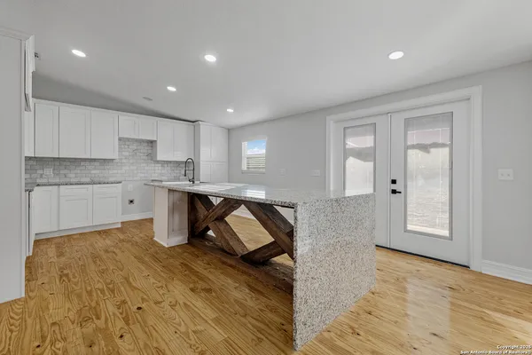 a living room with a sink furniture and kitchen view