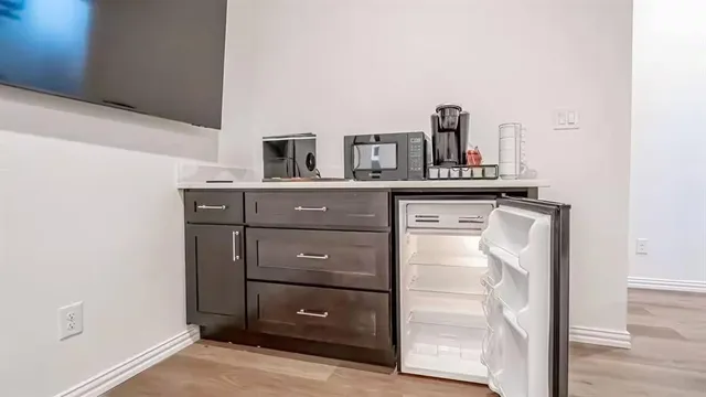 a kitchen with a refrigerator and cabinets