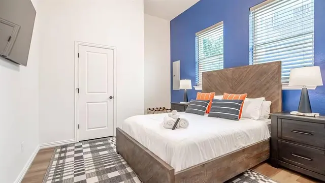 a bedroom with a bed and a lamp