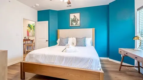 a bedroom with a bed and a flat screen tv