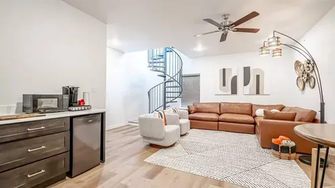 a kitchen with a sink cabinets and wooden floor