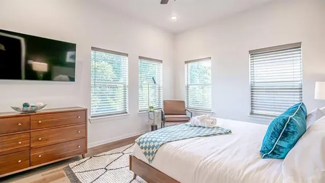 a bedroom with a bed and a flat screen tv