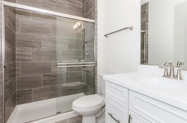 a bathroom with a sink toilet and shower