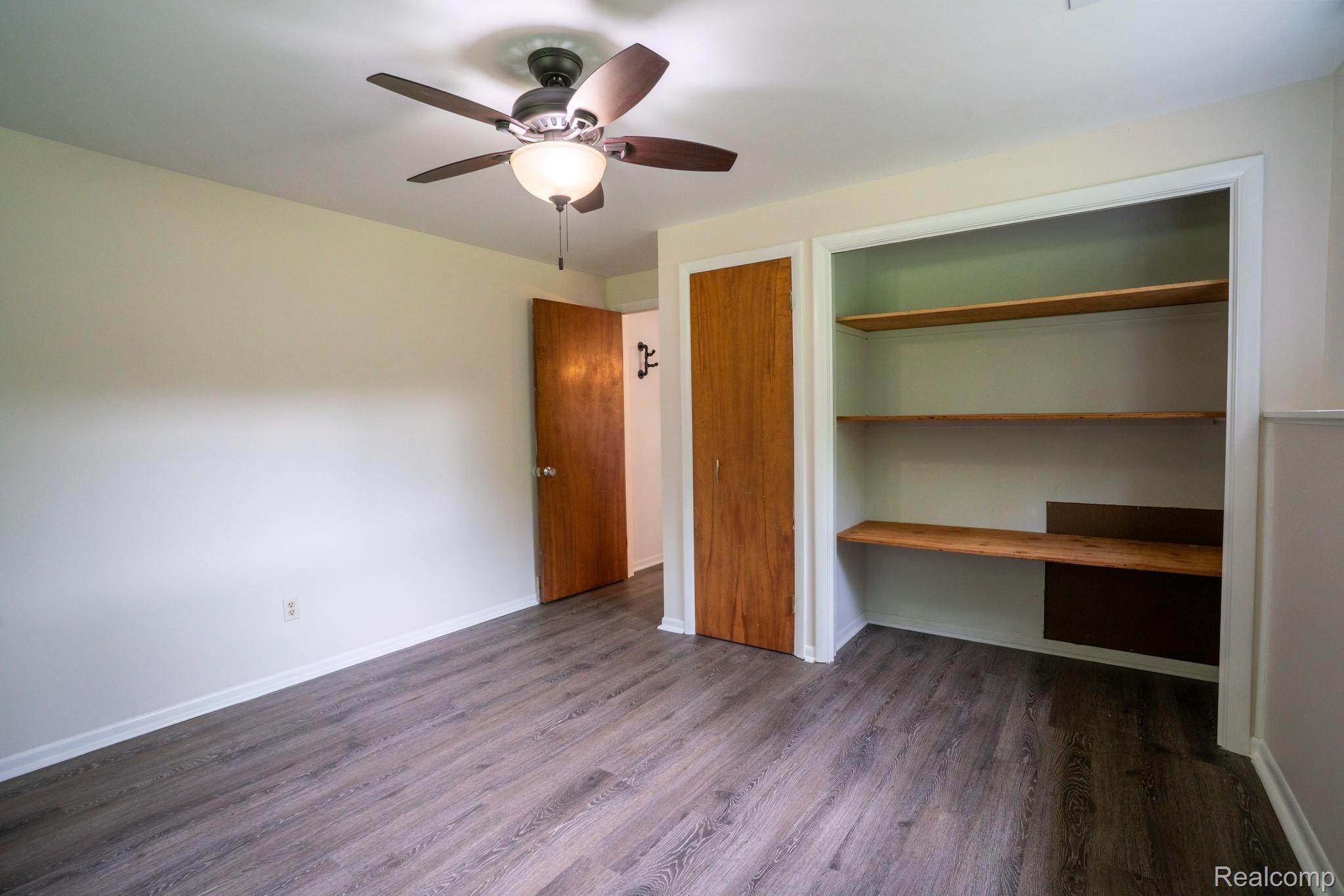 7333 Toma Road Dexter, MI 48130 - Photo 35 of 45 Wood-finish flooring throughout, complemented by a ceiling fan with integrated lighting