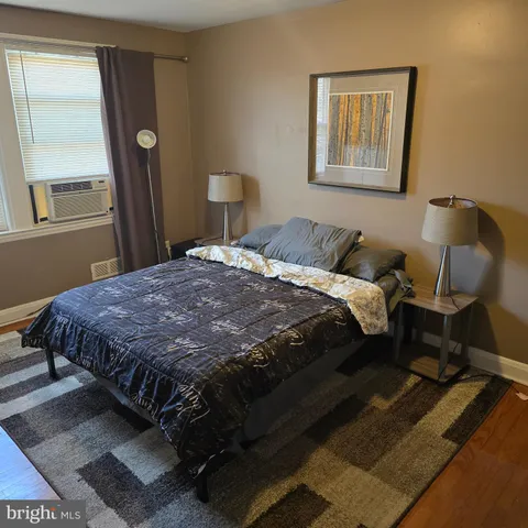 a bedroom with a bed and window