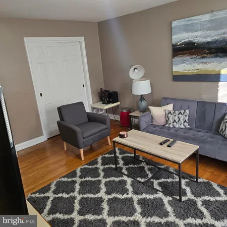 a living room with furniture and a rug