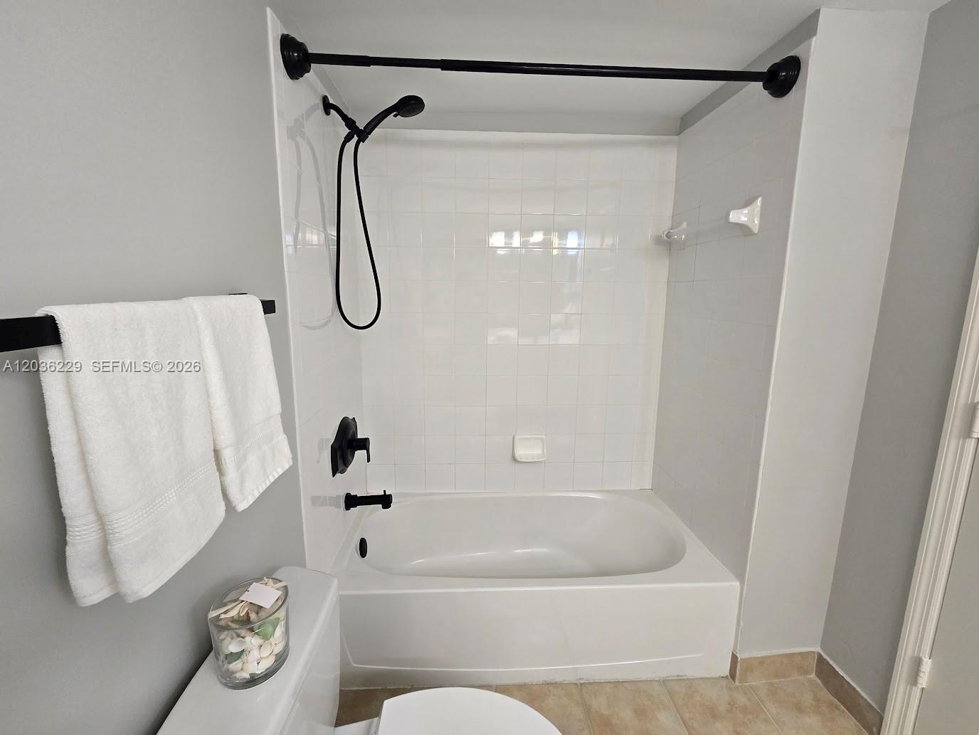 888 Douglas Road, Unit 605 Coral Gables, FL 33134 - Photo 15 of 21 a bathroom with a bath tub with a shower