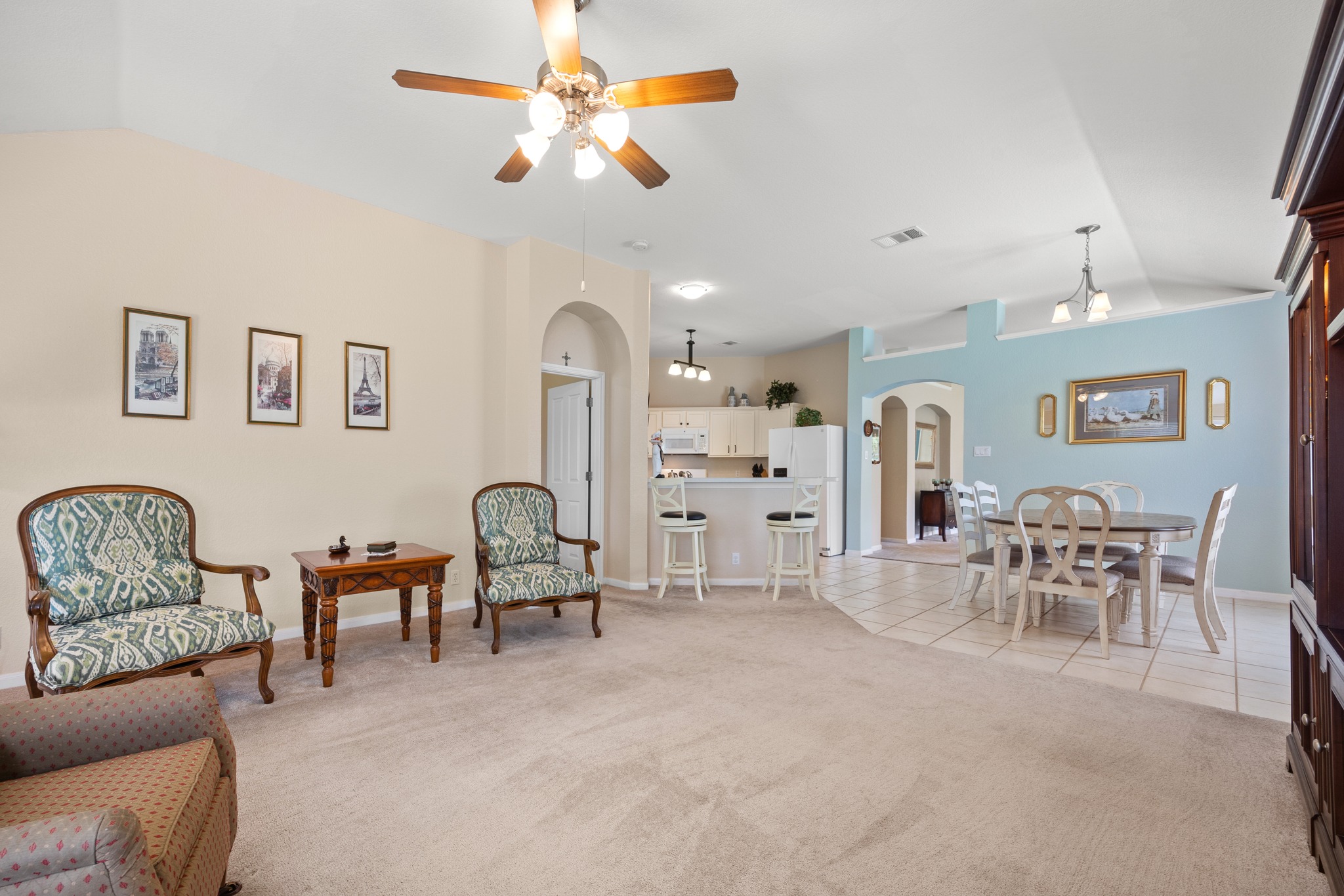 1108 Springbrook Road Pflugerville, TX 78660 - Photo 10 of 37 A well-lit living area featuring an open-concept design and varied flooring.