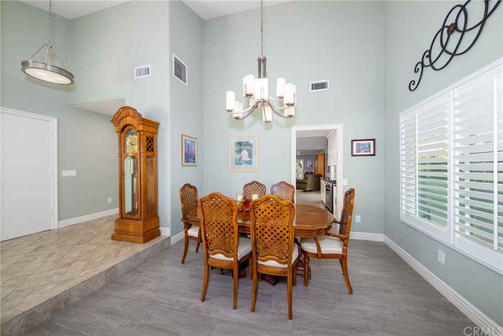 1817 Balboa Way Upland, CA 91784 - Photo 11 of 55 a dining room with furniture a chandelier and wooden floor
