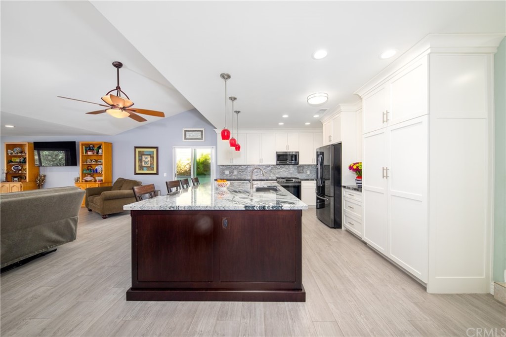 1817 Balboa Way Upland, CA 91784 - Photo 13 of 55 a view of kitchen with kitchen island stainless steel appliances wooden floor dining table and chairs