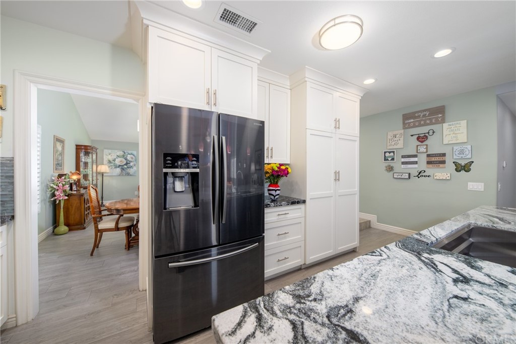 1817 Balboa Way Upland, CA 91784 - Photo 15 of 55 a kitchen with a refrigerator and a wooden floor