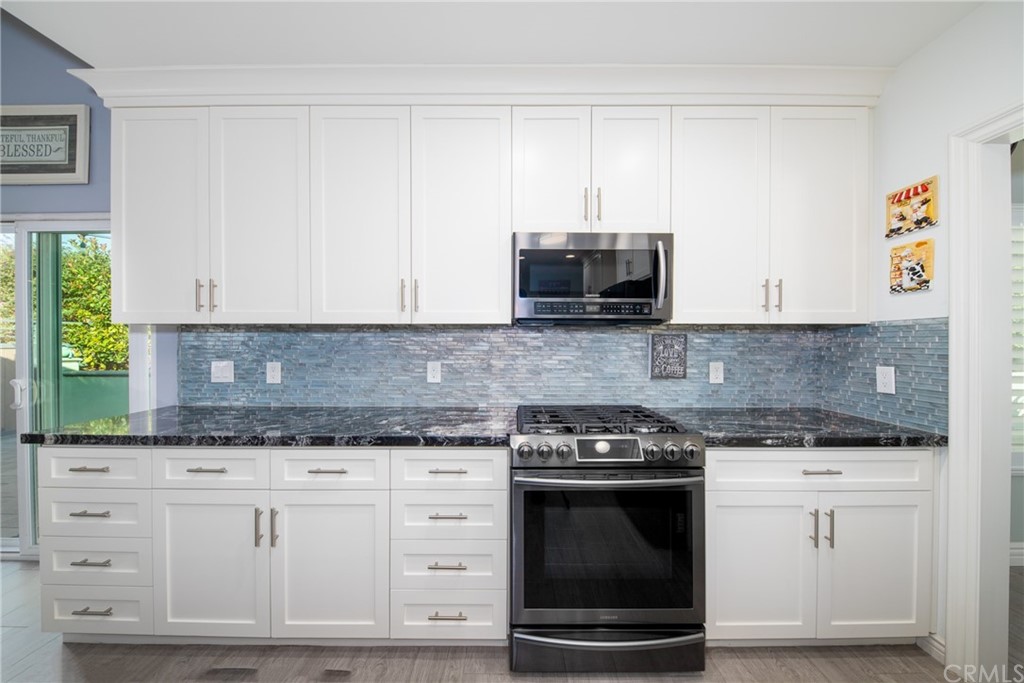 1817 Balboa Way Upland, CA 91784 - Photo 16 of 55 a kitchen with granite countertop white cabinets and appliances