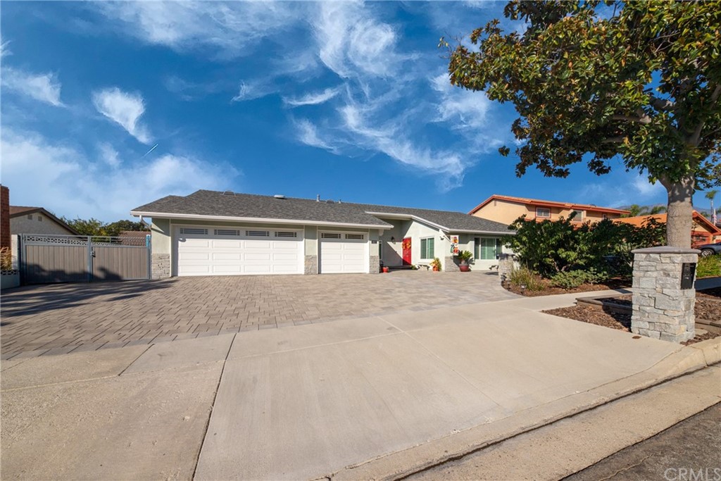 1817 Balboa Way Upland, CA 91784 - Photo 3 of 55 a front view of a house with a yard and garage