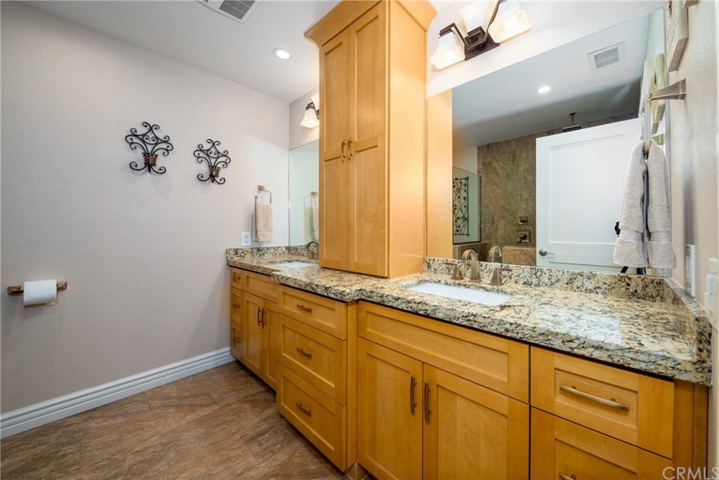 1817 Balboa Way Upland, CA 91784 - Photo 26 of 55 a bathroom with a granite countertop sink and a mirror