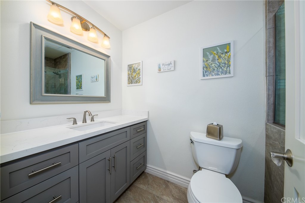1817 Balboa Way Upland, CA 91784 - Photo 31 of 55 a bathroom with a toilet sink and mirror