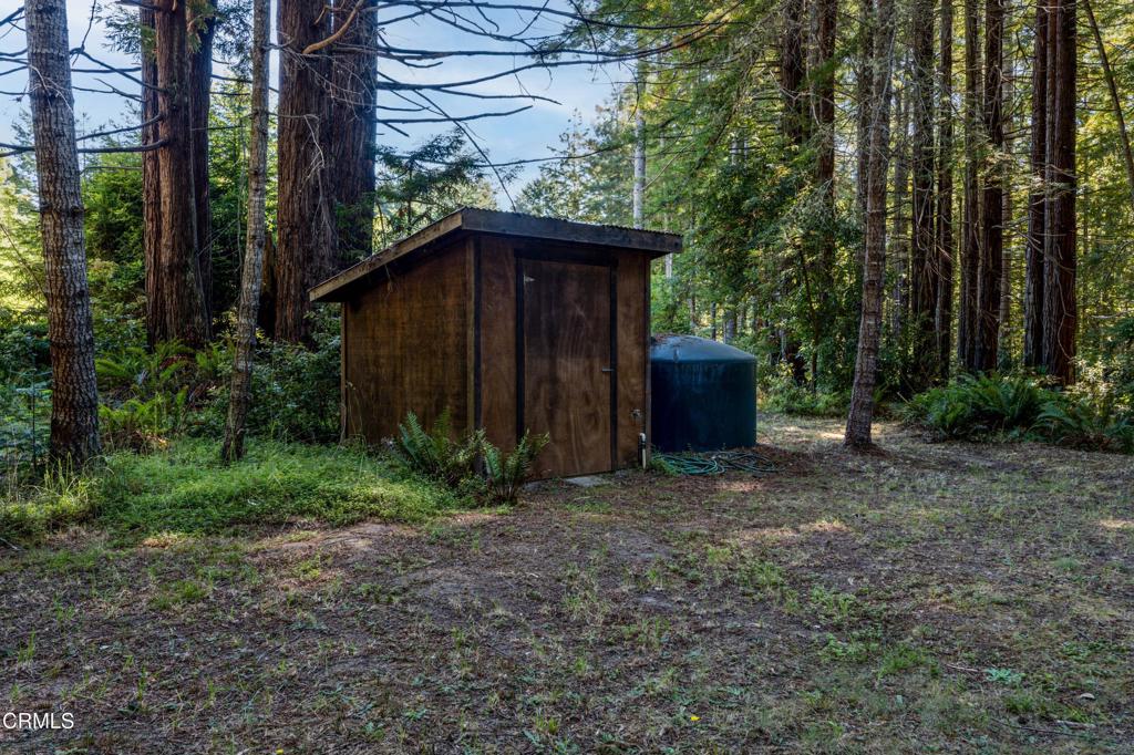 30651 Sherwood Road Fort Bragg, CA 95437 - Photo 23 of 27 a view of a wooden house with a yard