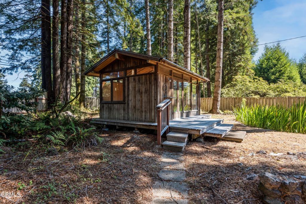 30651 Sherwood Road Fort Bragg, CA 95437 - Photo 3 of 27 a view of a small house with yard and sitting area