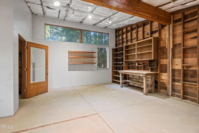 a view of an empty room with a fireplace and a chandelier