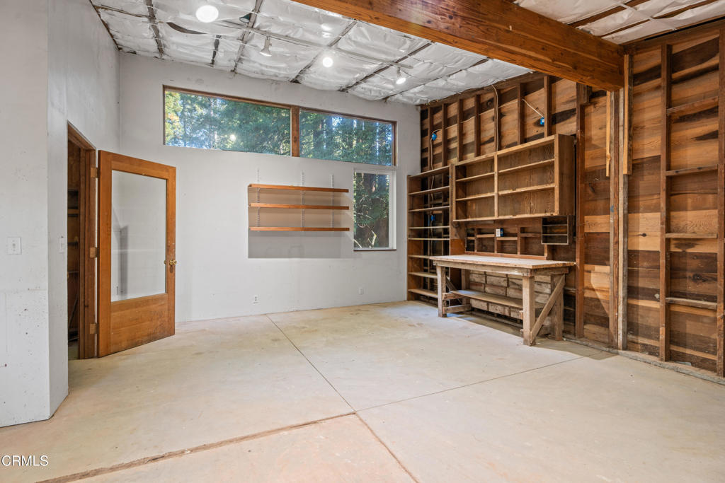 30651 Sherwood Road Fort Bragg, CA 95437 - Photo 8 of 27 a view of an empty room with a fireplace and a chandelier