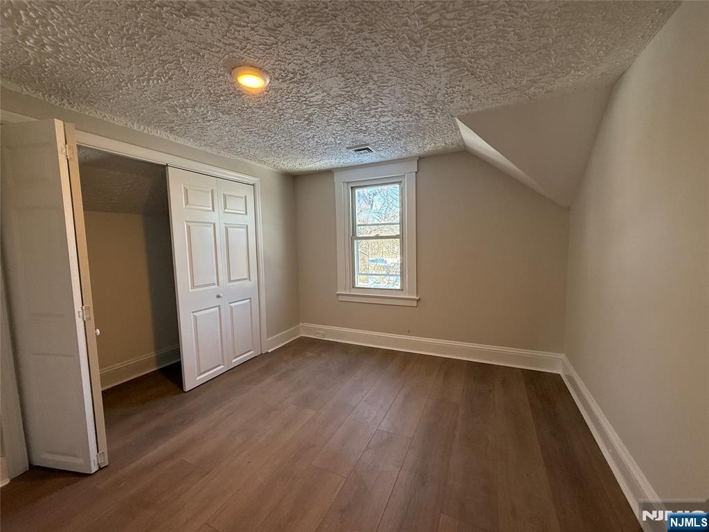 13 Mountainside Avenue Mahwah, NJ 07430 - Photo 6 of 11 an empty room with wooden floor and windows