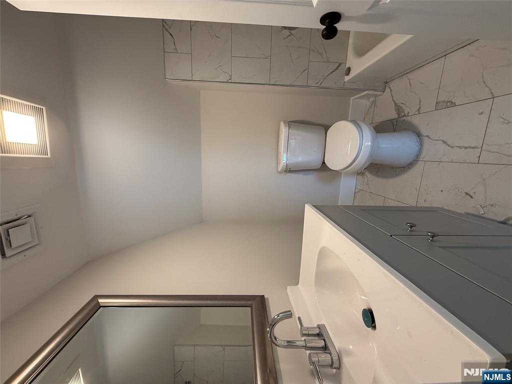 13 Mountainside Avenue Mahwah, NJ 07430 - Photo 7 of 11 a bathroom with a toilet sink and mirror