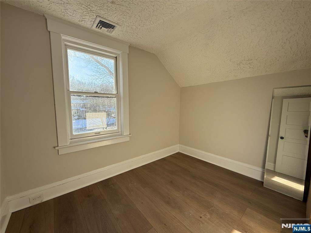 13 Mountainside Avenue Mahwah, NJ 07430 - Photo 8 of 11 an empty room with wooden floor and windows