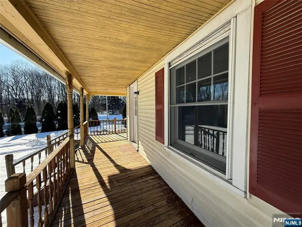 a balcony with table and chairs