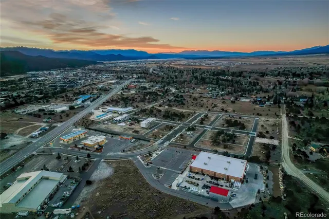 an aerial view of residential houses with city view