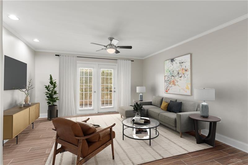 a living room with furniture a rug and a large window