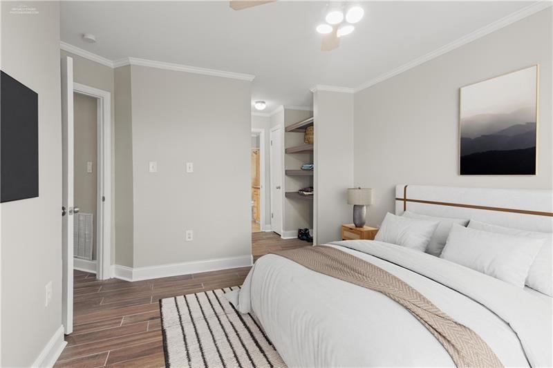 3655 Habersham Road Northeast, Unit A108 Atlanta, GA 30305 - Photo 11 of 30 a bedroom with a bed and a flat screen tv