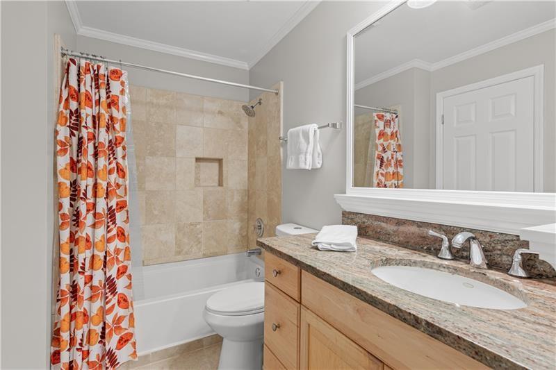 3655 Habersham Road Northeast, Unit A108 Atlanta, GA 30305 - Photo 12 of 30 a bathroom with a granite countertop sink toilet and shower
