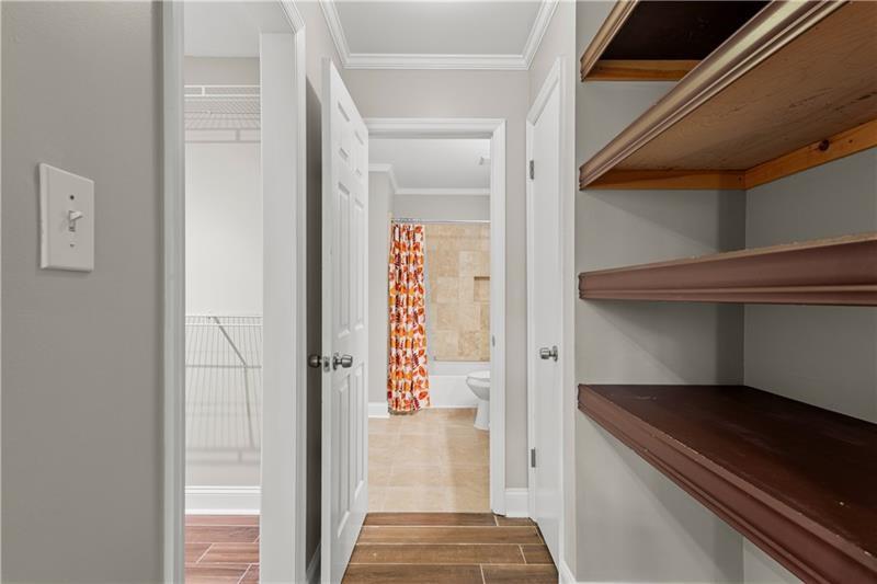 3655 Habersham Road Northeast, Unit A108 Atlanta, GA 30305 - Photo 16 of 30 a view of a hallway with wooden floor and staircase