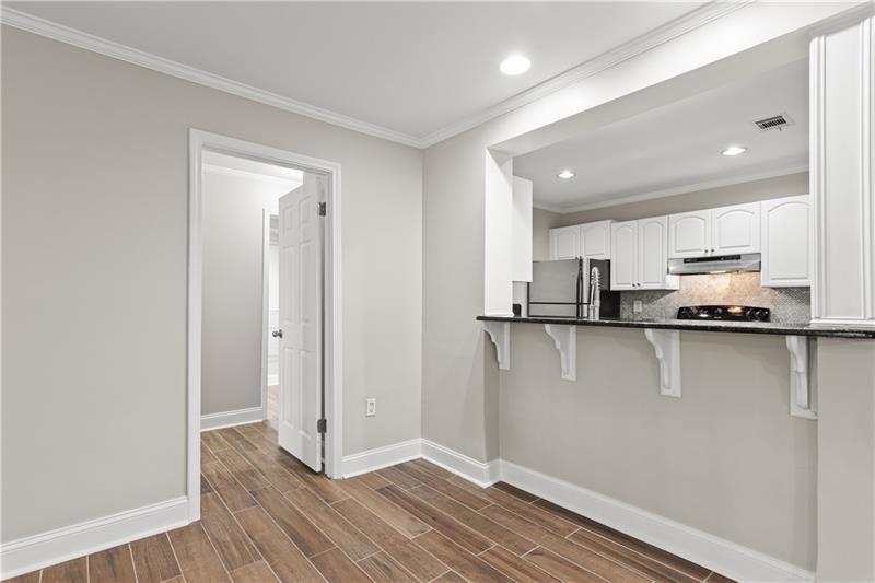 3655 Habersham Road Northeast, Unit A108 Atlanta, GA 30305 - Photo 22 of 30 a view of a kitchen with stainless steel appliances wooden floor and a window