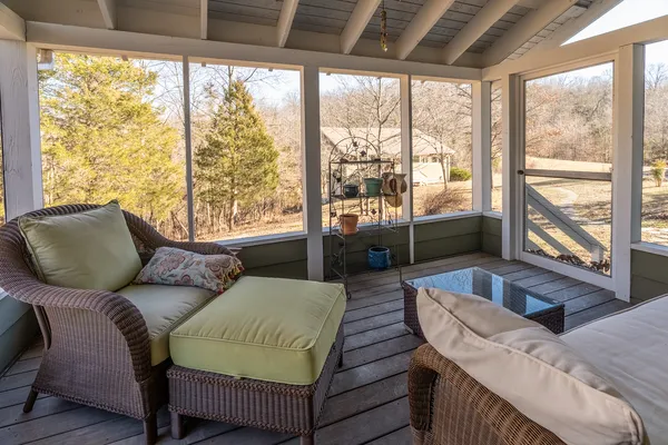 a spacious bedroom with a bed a dresser and wooden floor