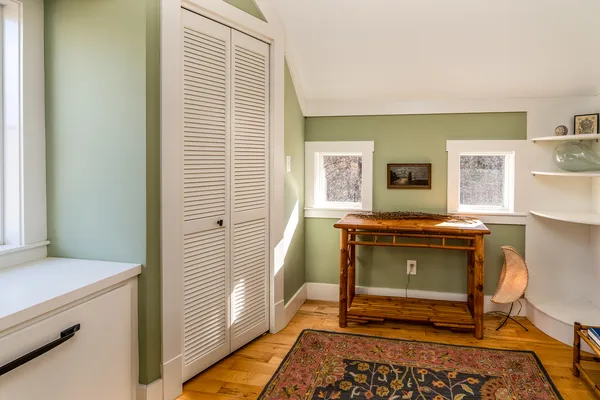 a bedroom with a bed and a large window