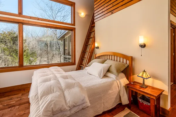 a living room with furniture and large windows