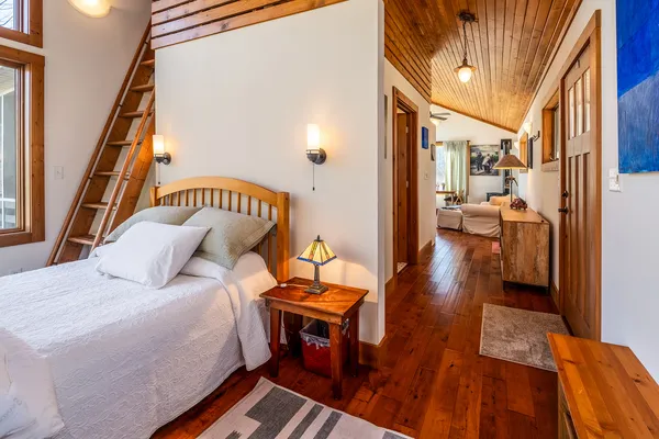 a living room with furniture a rug and a large window