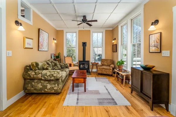 a living room with furniture fireplace and a large window