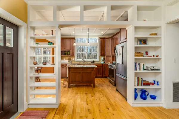 a kitchen with stainless steel appliances granite countertop wooden floors and sink