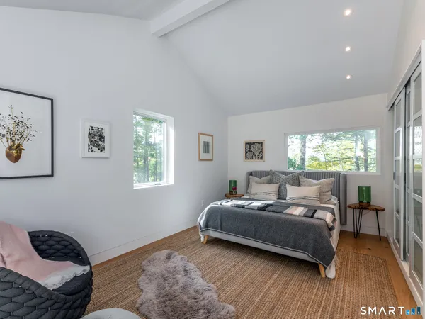 a living room with a bed furniture and a window